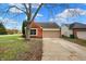 Lovely brick home with an attached garage, mature tree, and a well-manicured lawn at 7783 Park N Ct, Indianapolis, IN 46260