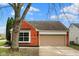Charming brick home with a two-car garage and well-maintained landscaping at 7783 Park N Ct, Indianapolis, IN 46260