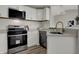 Beautiful kitchen featuring white cabinets, stainless steel appliances, and a modern faucet at 7783 Park N Ct, Indianapolis, IN 46260