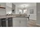 Contemporary kitchen with stainless steel appliances, white cabinets and view into the dining room at 7783 Park N Ct, Indianapolis, IN 46260