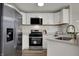 Modern kitchen featuring stainless steel appliances, white cabinetry, and ample counter space at 7783 Park N Ct, Indianapolis, IN 46260