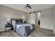 Inviting bedroom featuring a ceiling fan and ensuite bathroom with sliding barn door at 7783 Park N Ct, Indianapolis, IN 46260
