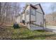 Exterior view of home and backyard featuring a riding lawnmower at 7980 S State Road 135, Columbus, IN 47201
