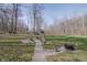 Inviting backyard featuring a fire pit with a gravel path, perfect for outdoor gatherings at 7980 S State Road 135, Columbus, IN 47201