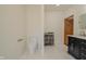 Well-lit bathroom featuring white tile, modern toilet, and vanity with black cabinet at 7980 S State Road 135, Columbus, IN 47201