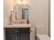 Bathroom featuring vanity with dark wood cabinets, light countertop, and a square mirror at 7980 S State Road 135, Columbus, IN 47201
