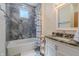 Updated bathroom with gray tile, shower-tub combo, granite vanity, and modern fixtures at 7980 S State Road 135, Columbus, IN 47201