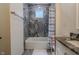 Stylish bathroom with gray tile, shower-tub combo, and granite vanity at 7980 S State Road 135, Columbus, IN 47201