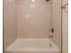 Clean white bathtub with showerhead and neutral tiling at 7980 S State Road 135, Columbus, IN 47201