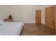 Bedroom with hardwood floors and rustic wooden doors to closets at 7980 S State Road 135, Columbus, IN 47201