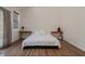 Bedroom with hardwood floors, vase of tulips, and two small bedside tables at 7980 S State Road 135, Columbus, IN 47201