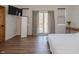 Bedroom with hardwood floors, TV, mirror, area rug, sliding glass doors to outdoor deck at 7980 S State Road 135, Columbus, IN 47201
