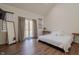 Bedroom with hardwood floors, mirror, area rug, sliding glass doors to outdoor deck at 7980 S State Road 135, Columbus, IN 47201