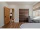 Inviting bedroom with natural light, laminate floor, wood door, and closet at 7980 S State Road 135, Columbus, IN 47201