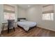 Cozy bedroom with natural light, laminate floor, and modern gray accent chair at 7980 S State Road 135, Columbus, IN 47201