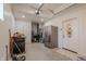 View of an unfinished garage with a stainless steel refrigerator, garage door opener, and heater unit at 7980 S State Road 135, Columbus, IN 47201