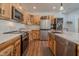 Well-lit kitchen showcasing natural wood cabinets, a stainless steel sink, and marble countertops at 7980 S State Road 135, Columbus, IN 47201