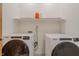 Laundry room with washer and dryer and shelf with cleaning supplies at 7980 S State Road 135, Columbus, IN 47201