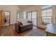 Living room with hardwood floors, TV, area rug, and sliding glass doors to outdoor deck at 7980 S State Road 135, Columbus, IN 47201