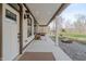 Inviting covered porch with a front door and ample space for outdoor decor and relaxation at 7980 S State Road 135, Columbus, IN 47201