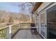 Outdoor porch with wooden flooring, railing, and a view of the nature in the background at 7980 S State Road 135, Columbus, IN 47201