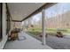 Covered porch with recessed lights features a swing and view of the expansive backyard at 7980 S State Road 135, Columbus, IN 47201