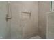 Elegant shower with stylish tile, glass door, and built-in shelving for toiletries at 7980 S State Road 135, Columbus, IN 47201