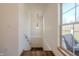 Staircase with wood floors and railing with view to the outdoor deck at 7980 S State Road 135, Columbus, IN 47201