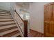 Staircase with wood steps and railing, leading to an open living area at 7980 S State Road 135, Columbus, IN 47201