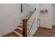 Staircase with wood steps and railing, white risers and spindles at 7980 S State Road 135, Columbus, IN 47201