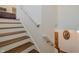 Staircase with wood steps and white risers, leading to an upper floor at 7980 S State Road 135, Columbus, IN 47201