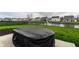 This backyard has a covered table, green grass, black mulch and a black metal fence at 8405 Whitaker Valley Blvd, Indianapolis, IN 46237