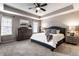Comfortable bedroom features a queen-size bed, a ceiling fan and a dresser at 8405 Whitaker Valley Blvd, Indianapolis, IN 46237