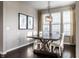 Dining room with an wooden table and white chairs, complemented by natural light from a large window at 8405 Whitaker Valley Blvd, Indianapolis, IN 46237