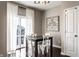 Dining room features a dark wood table with white chairs and a sliding glass door for natural light at 8405 Whitaker Valley Blvd, Indianapolis, IN 46237