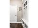 Functional mudroom area featuring a built-in bench with storage and a convenient key rack by the door at 8405 Whitaker Valley Blvd, Indianapolis, IN 46237