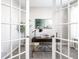 Bright home office featuring french doors and a wooden desk with gold legs at 8405 Whitaker Valley Blvd, Indianapolis, IN 46237