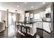 Kitchen with dark wood floors, an island with bar stool seating, and white cabinets at 8405 Whitaker Valley Blvd, Indianapolis, IN 46237