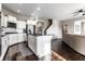 Bright, open kitchen with a central island, stainless steel appliances, and views into the adjacent living room at 8405 Whitaker Valley Blvd, Indianapolis, IN 46237
