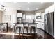Open kitchen with an island, stainless steel appliances, white cabinets, and dark hardwood floors at 8405 Whitaker Valley Blvd, Indianapolis, IN 46237