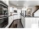 Modern kitchen with stainless steel appliances, white cabinetry, granite countertops, and hardwood flooring at 8405 Whitaker Valley Blvd, Indianapolis, IN 46237