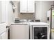 This laundry room has a washer, dryer, cabinets, and water heater at 8405 Whitaker Valley Blvd, Indianapolis, IN 46237