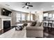 Open concept living room featuring a fireplace, ceiling fan, and a large, comfortable sectional sofa at 8405 Whitaker Valley Blvd, Indianapolis, IN 46237