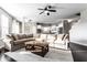 Bright living room with a large sectional sofa, a decorative rug, and a dark wood coffee table at 8405 Whitaker Valley Blvd, Indianapolis, IN 46237