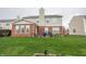 Large backyard with a brick patio and green grass at 8744 N Aspen Way, McCordsville, IN 46055