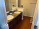 Well-lit bathroom showcasing a double vanity, dark wood cabinets, and neutral countertops at 8744 N Aspen Way, McCordsville, IN 46055