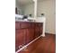 Bathroom featuring a double sink, vanity, granite countertop, and wood cabinets at 8744 N Aspen Way, McCordsville, IN 46055