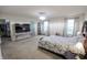 This bedroom includes a bed, two windows with curtains, and a large television at 8744 N Aspen Way, McCordsville, IN 46055