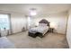 Bright bedroom with carpet floors, two windows with curtains, and a decorative chandelier at 8744 N Aspen Way, McCordsville, IN 46055