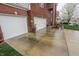Long concrete driveway leading to the brick home's two-car garage at 8744 N Aspen Way, McCordsville, IN 46055